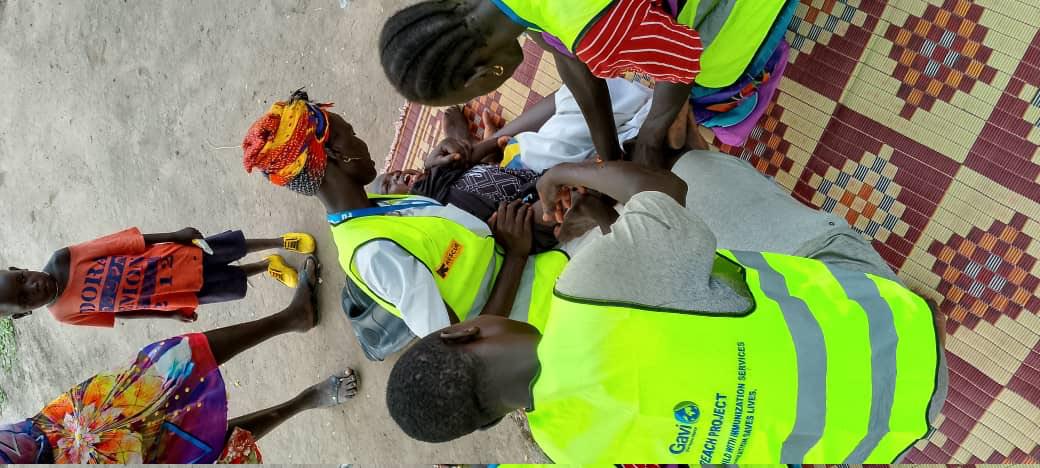 Health worker vaccinating child
